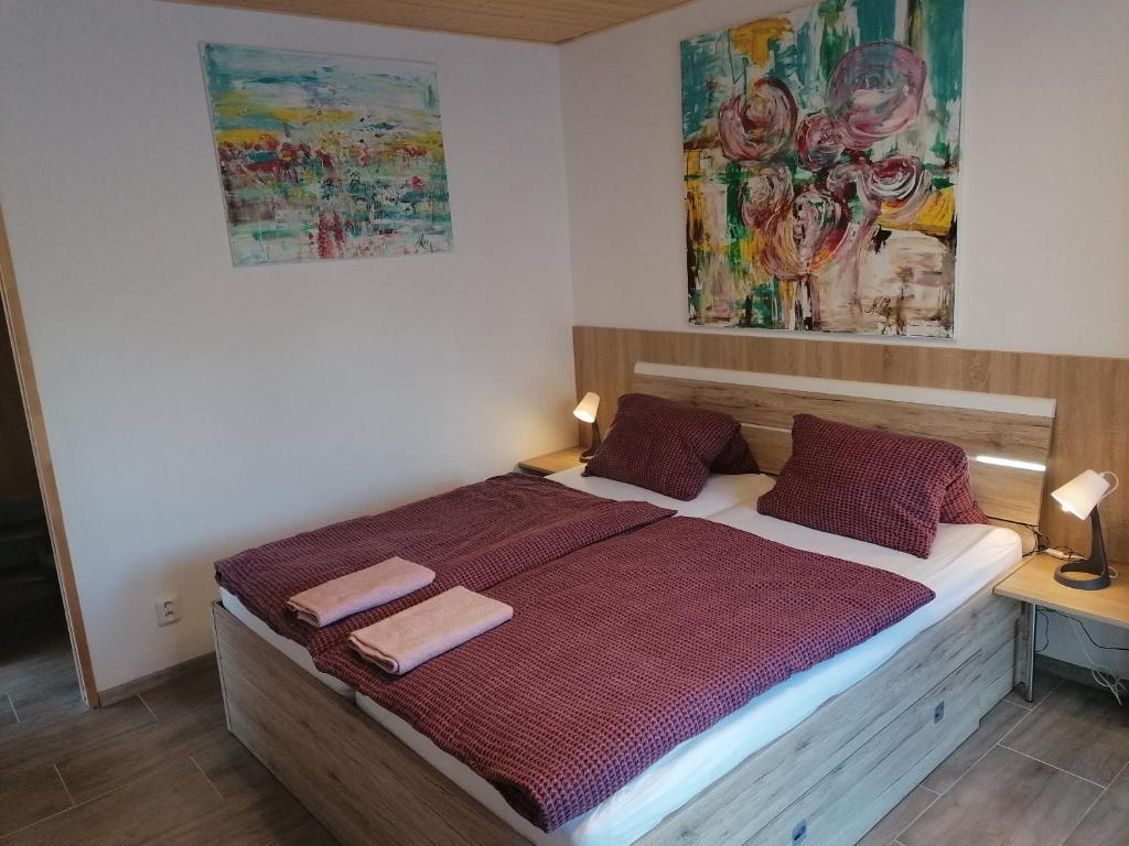 a bedroom with a bed with two towels on it at Penzion Loren in Františkovy Lázně