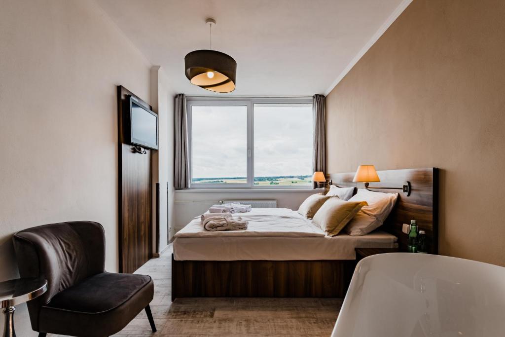Postel nebo postele na pokoji v ubytování Hotel Palcát
