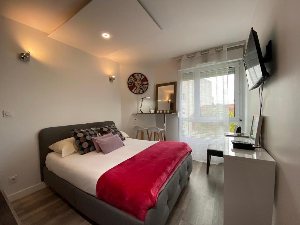 a bedroom with a large bed with a red blanket at Studio Gare Part Dieu in Lyon