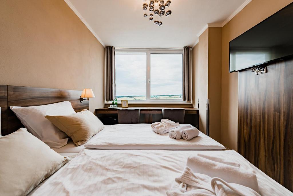 Postel nebo postele na pokoji v ubytování Hotel Palcát