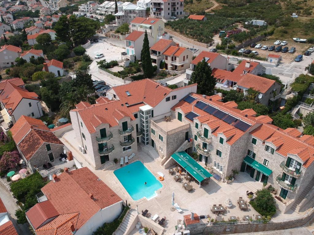 an aerial view of a building with a swimming pool at Hotel Ivan Dujmović Dvori in Bol