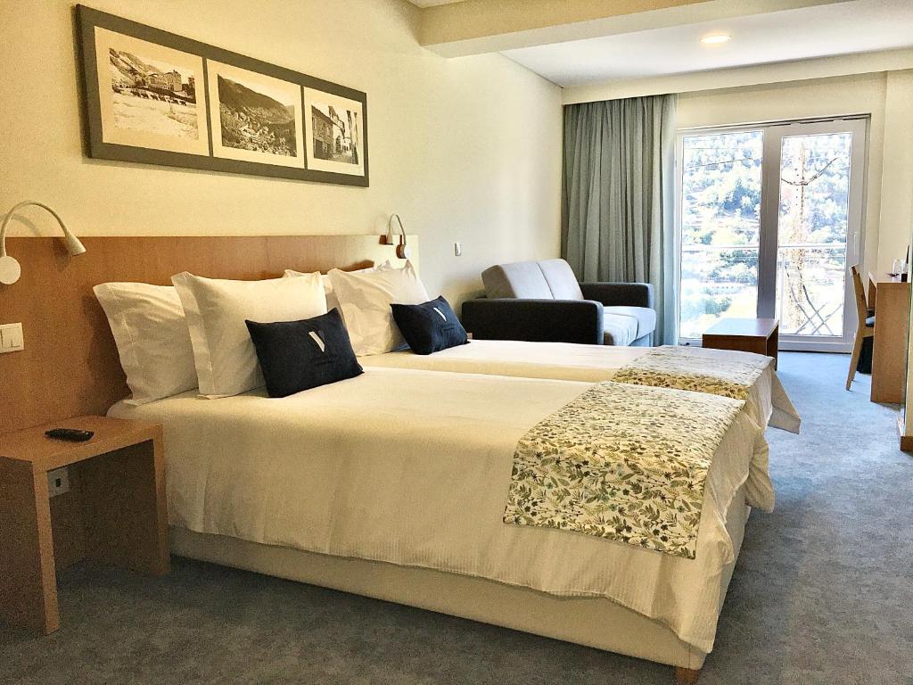 Ліжко або ліжка в номері Hotel da Vila