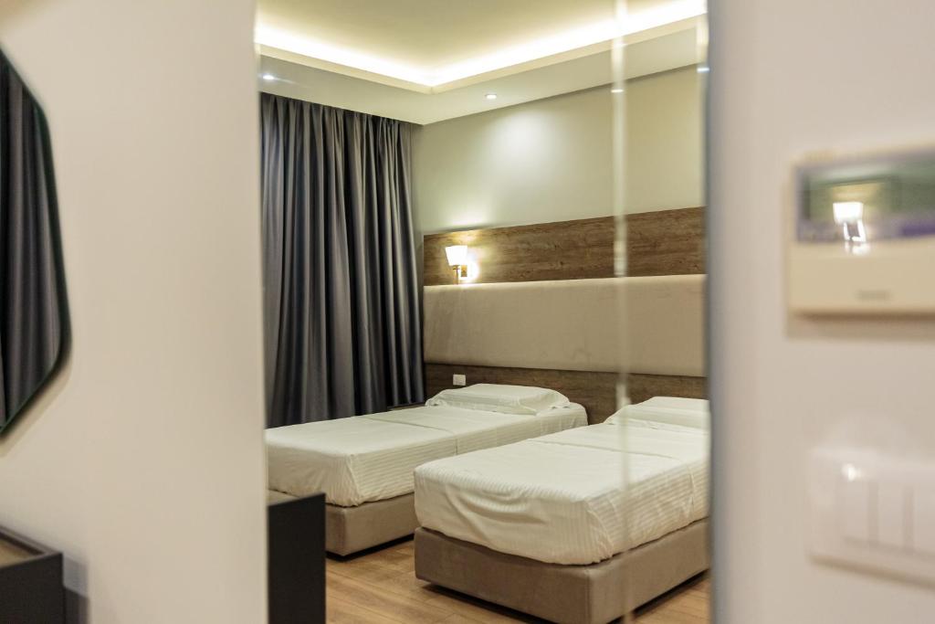Postel nebo postele na pokoji v ubytování Real Hotel