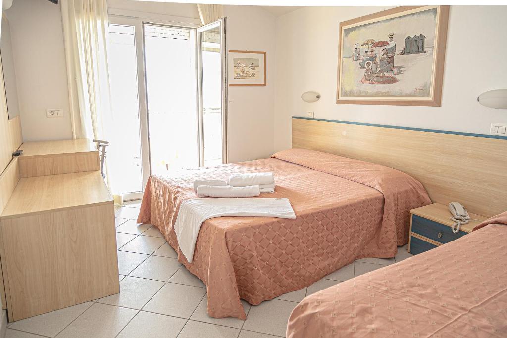 Postel nebo postele na pokoji v ubytování Hotel Royal Inn