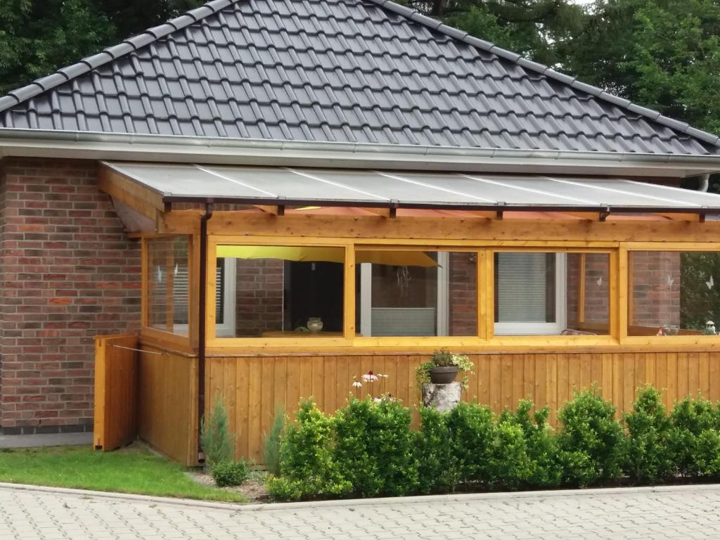 a house with a solarium on top of it at Ferienhaus Am Barenberg in Thülsfeld