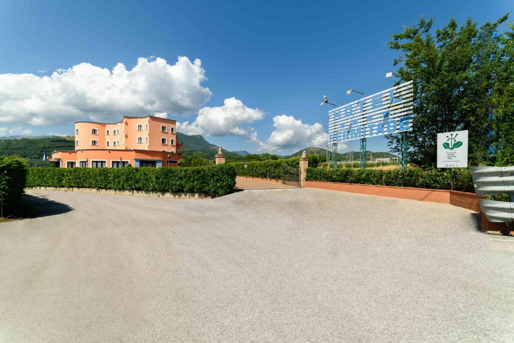 a road with a building in the background with a building at Hotel Hermitage in Polla