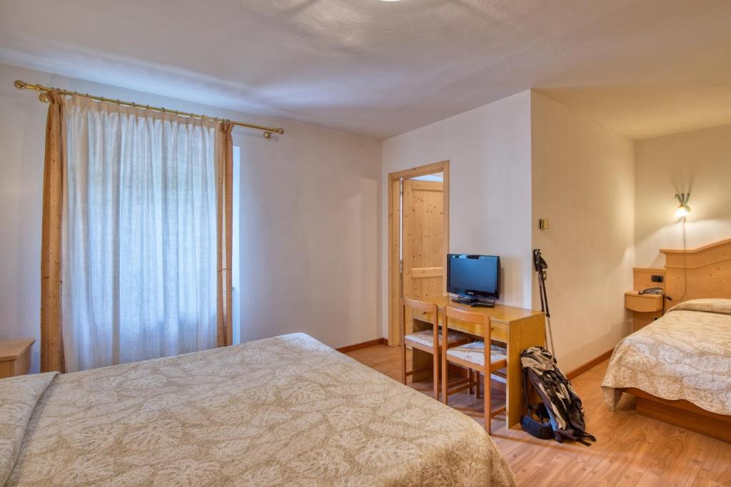 Postel nebo postele na pokoji v ubytování Albergo Moleta