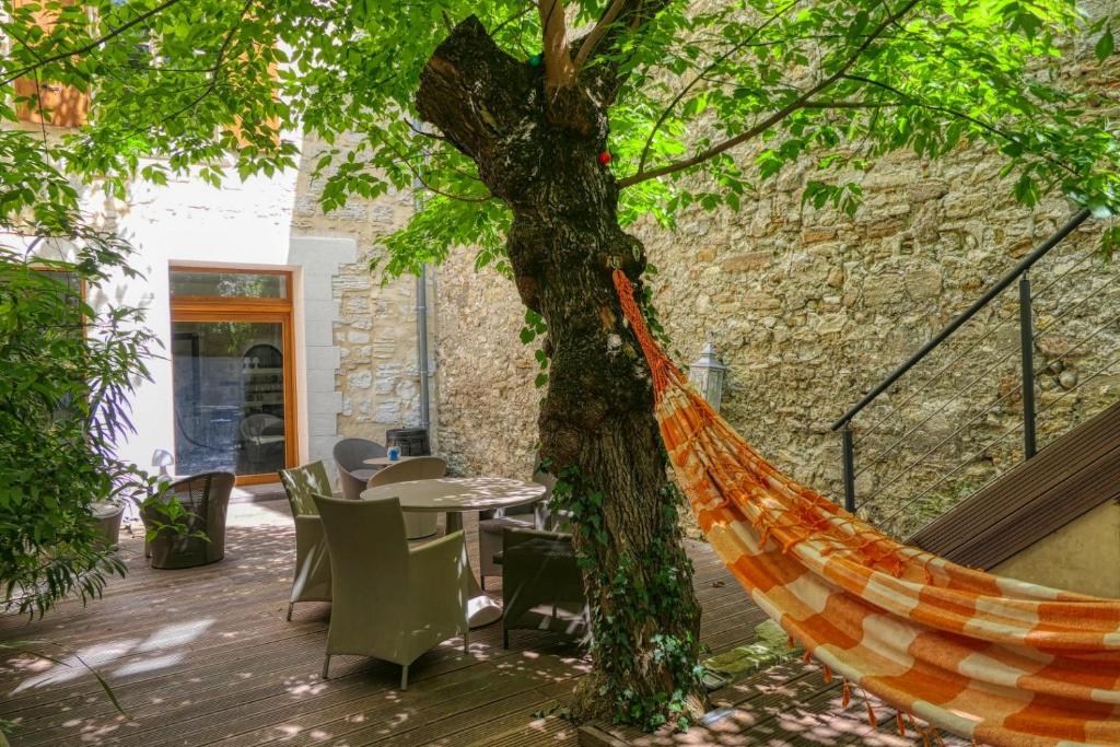 a hammock tied to a tree on a patio at la chambre des petits papes, intra muros in Avignon