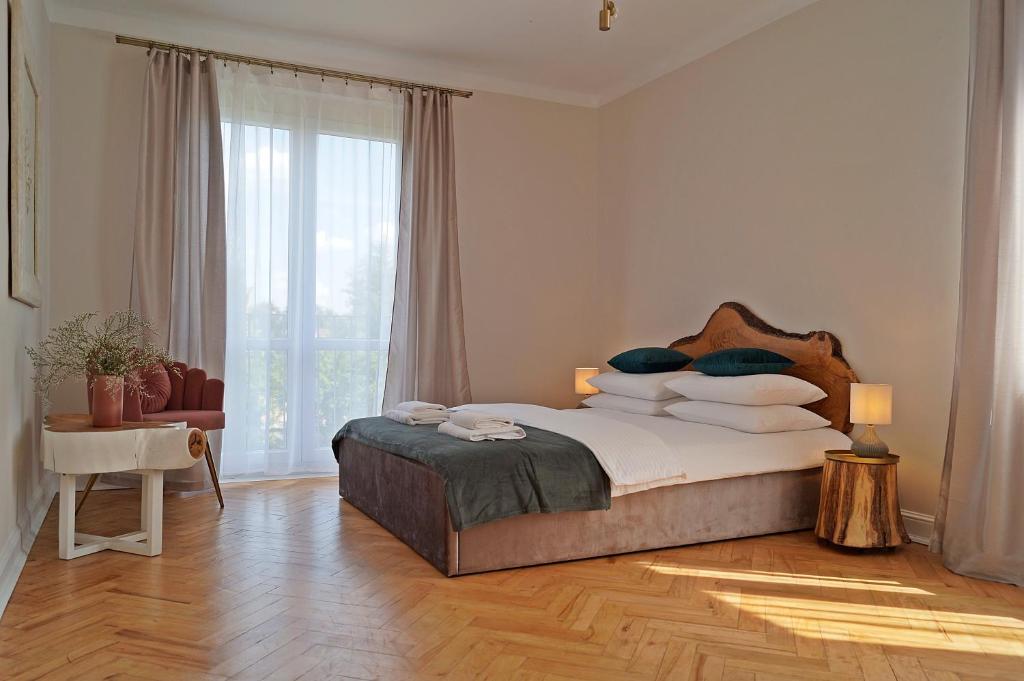 a bedroom with a bed and a large window at Apartament Pisz Centrum 7 in Pisz