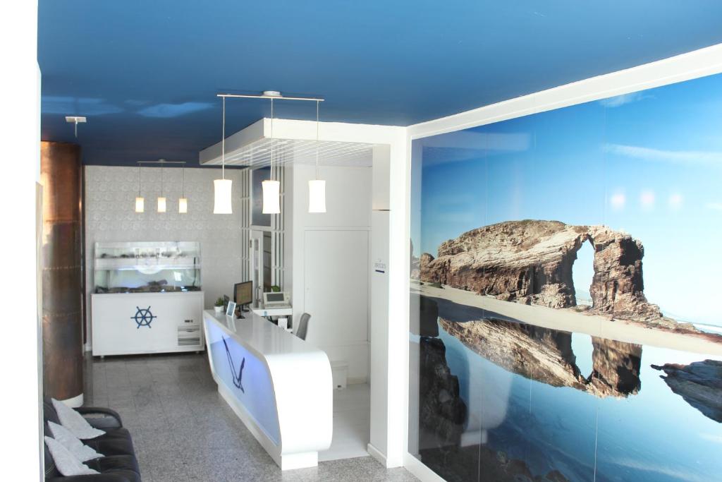 a room with a wall with an aquarium at Hotel Voar in Ribadeo