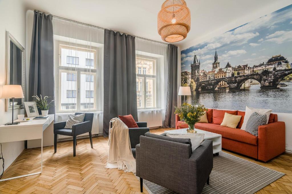 a living room with a red couch and views of the city at APT in center Prague w Netflix by Michal&Friends in Prague