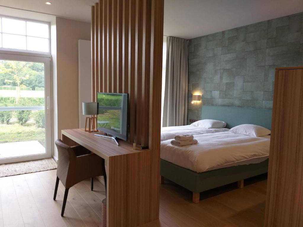 Postel nebo postele na pokoji v ubytování Hotel B - Boskapelhoeve