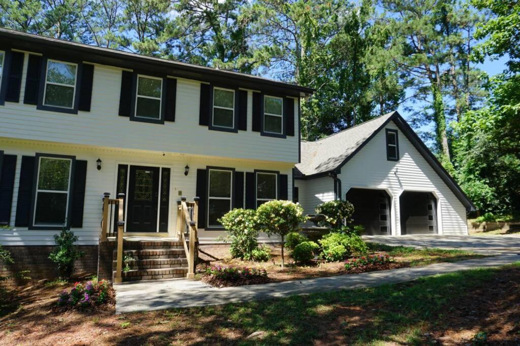 a white house with black shutters at Beautiful & large newly renovated 5 bedroom house. in Marietta