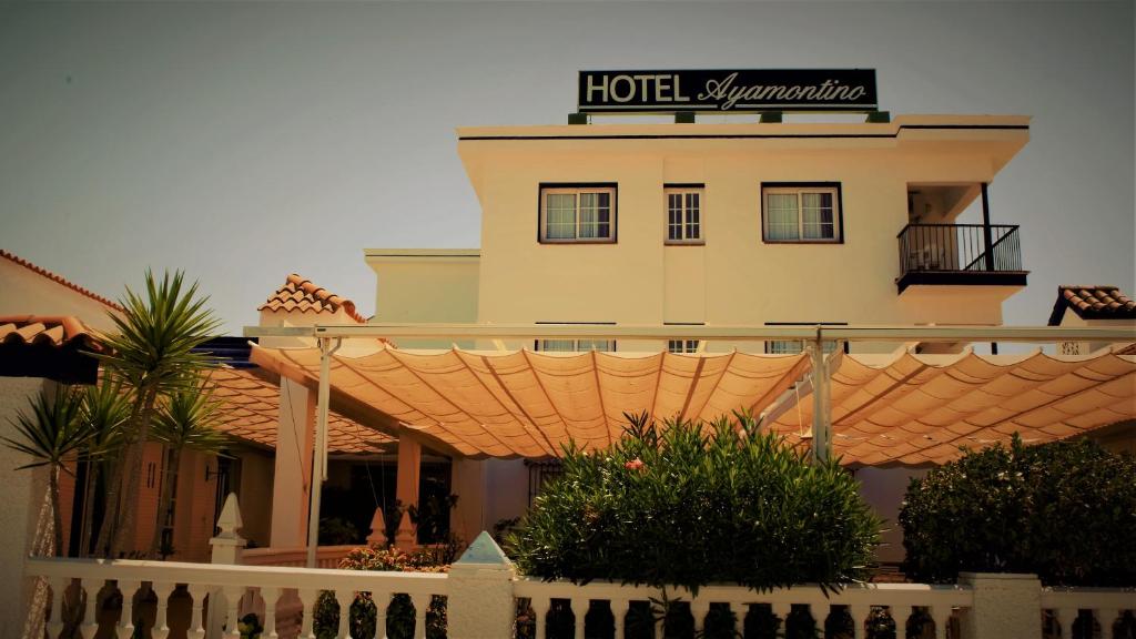 a hotel with a sign on top of a building at Hotel Ayamontino in Punta Umbría