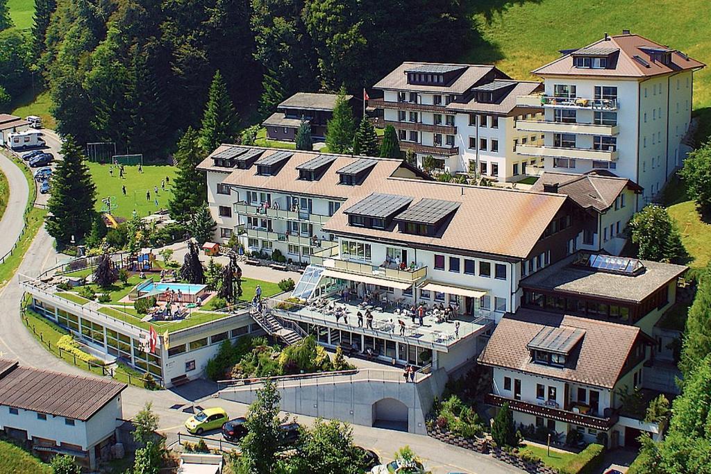 an aerial view of a large building with a resort at Ferienwohnungen JHS in Seewis im Prättigau