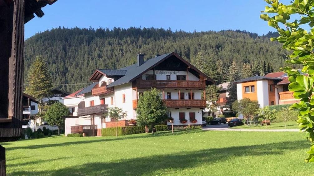 a large house in the middle of a green field at Schoenangerhof in Seefeld in Tirol