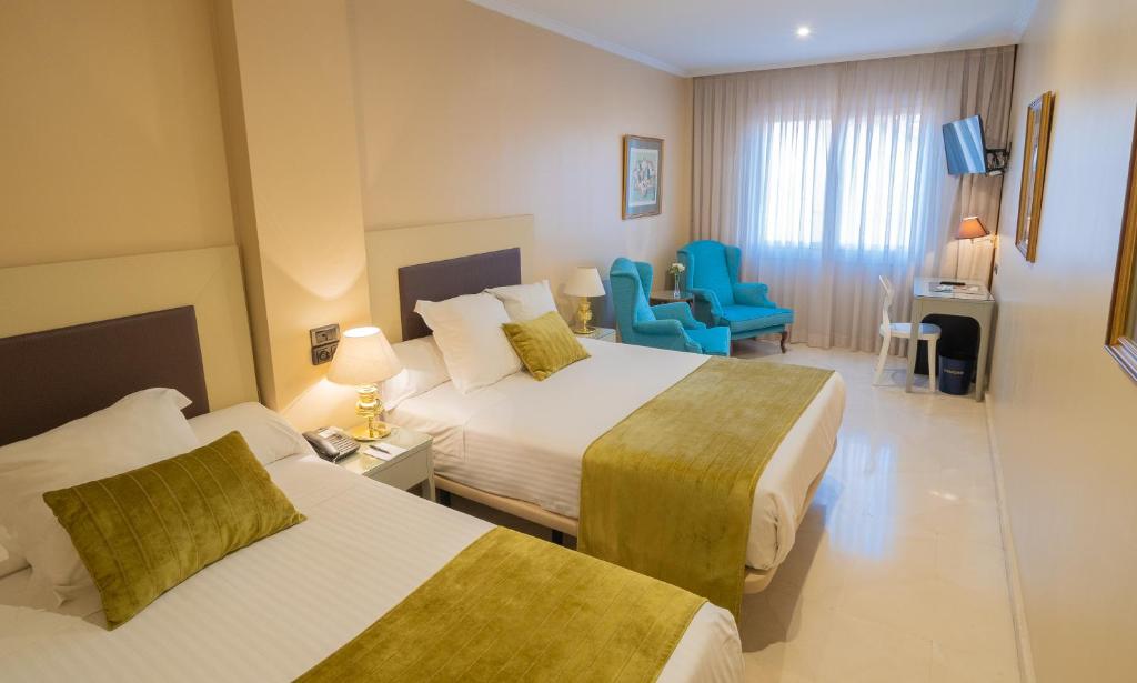 Postel nebo postele na pokoji v ubytování Hotel Sancho