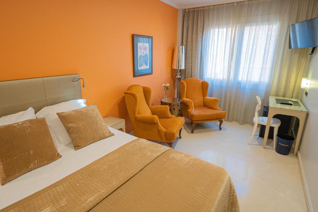 Postel nebo postele na pokoji v ubytování Hotel Sancho