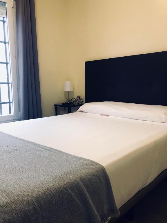 Cama o camas de una habitación en Hospedería Luis de Góngora