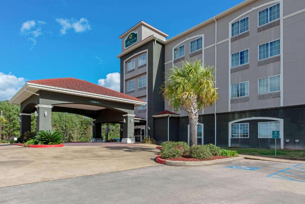 a building with a clock tower on top of it at La Quinta by Wyndham Leesville Ft. Polk in Leesville