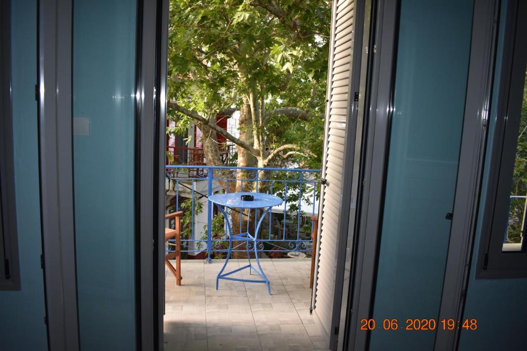 a door open to a patio with a table and a stool at The central house! in Raches
