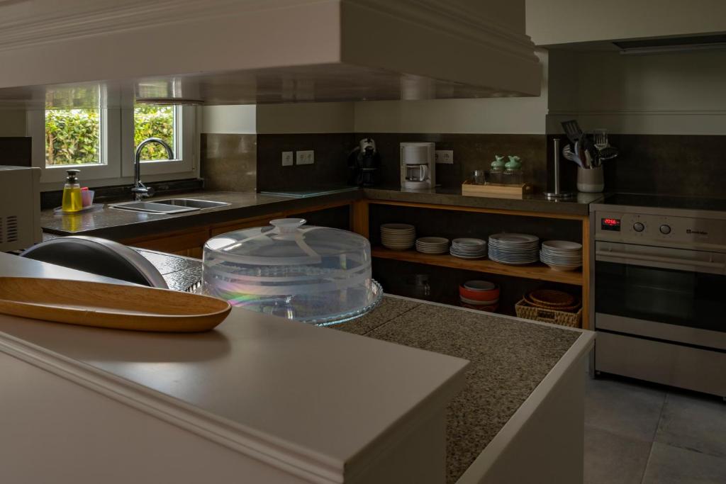 a kitchen with a sink and a counter top at Casa da Quinta in Vila Franca do Campo