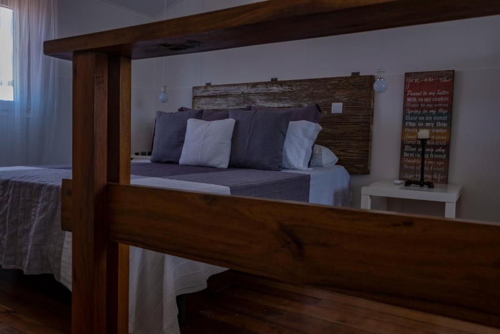 a bedroom with a bed with a large wooden frame at Casa da Quinta in Vila Franca do Campo