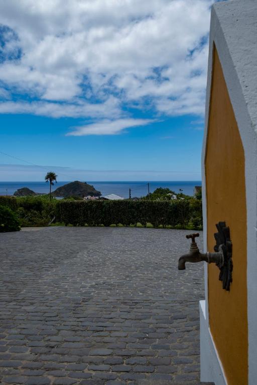 a water faucet on the side of a building at Casa da Quinta in Vila Franca do Campo