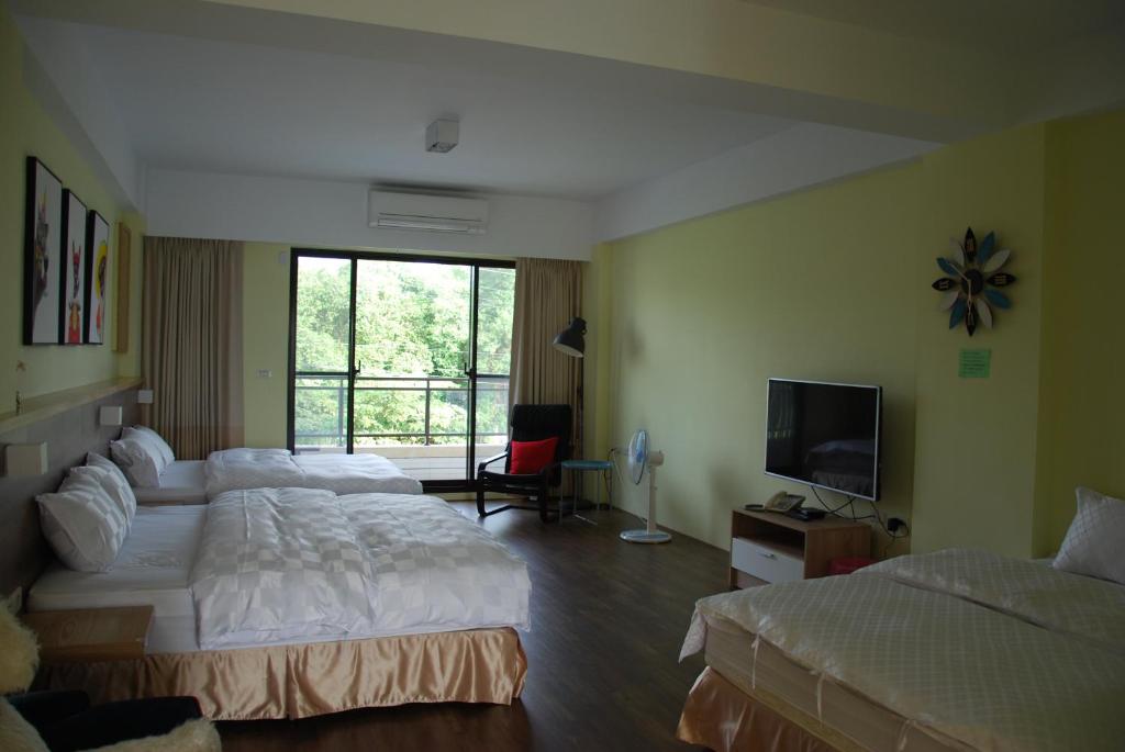 Postel nebo postele na pokoji v ubytování Sunny Sky Homestay