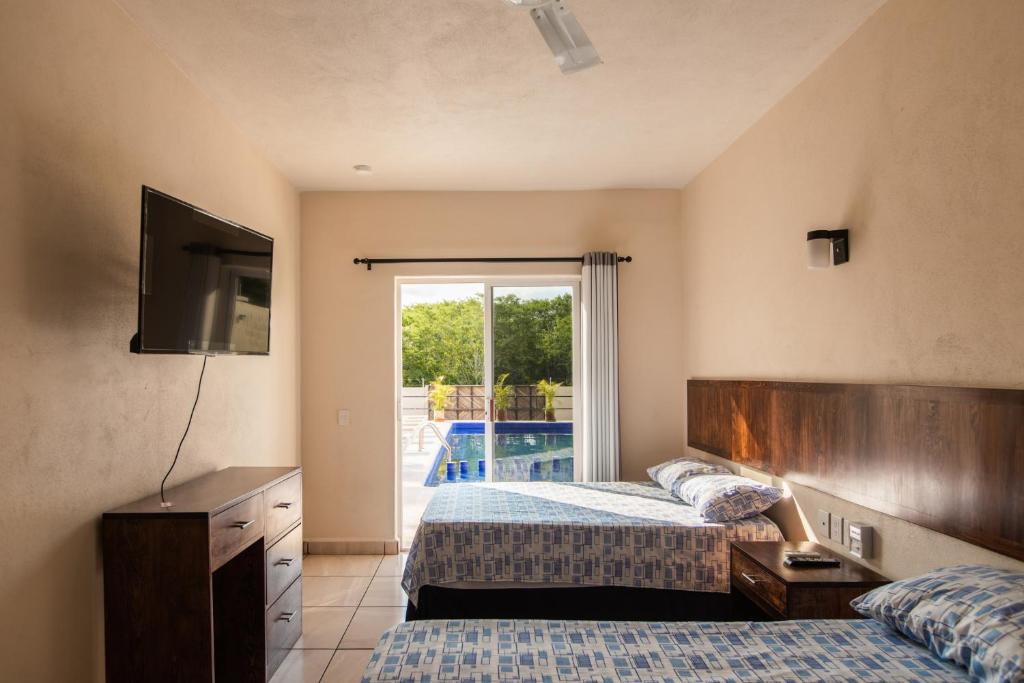 מיטה או מיטות בחדר ב-hotel isla Bonita