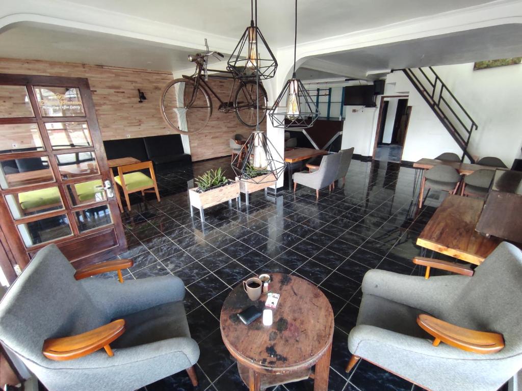 a lobby with chairs and a table in a room at Dieng Plateau Guest House in Diyeng