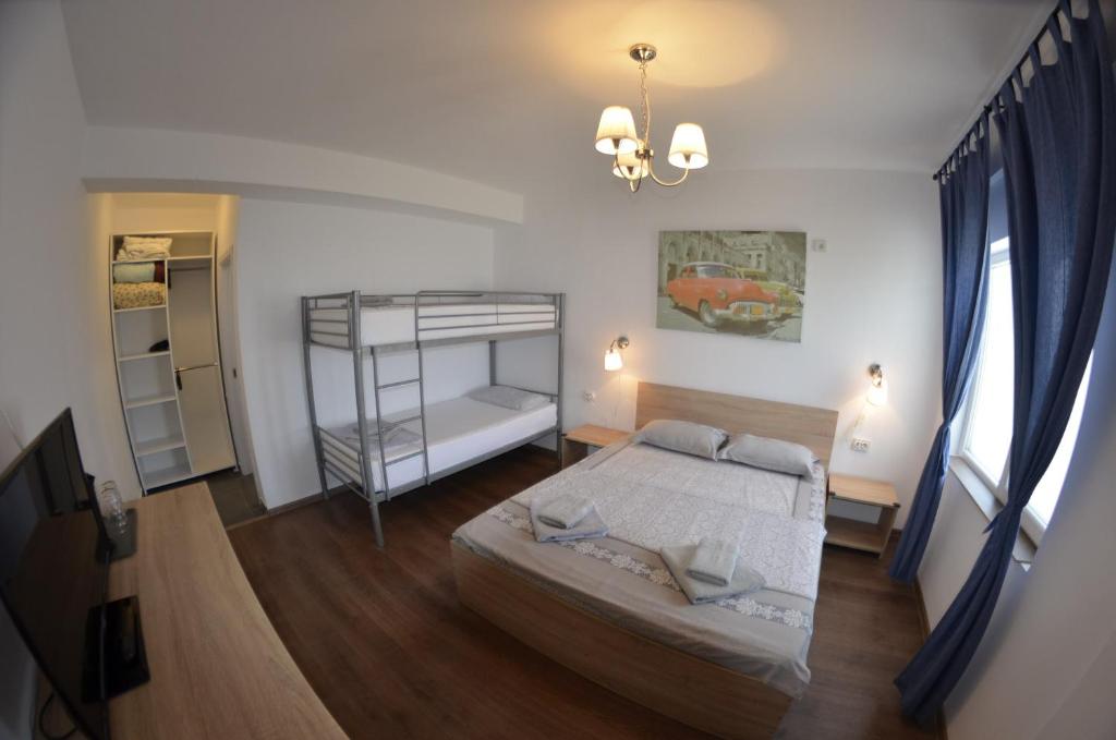 a bedroom with a bed and a bunk bed at Casa Robinson in Vama Veche