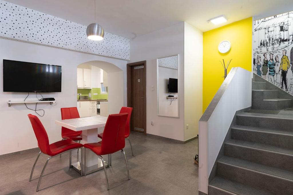 a kitchen with a dining room table and chairs at Vajda 15 Hostel Budapest in Budapest