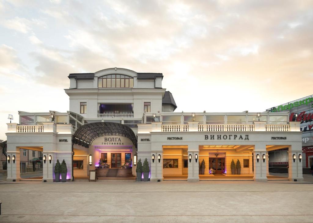 a large white building with a shopping center at Hotel Volga in Engels