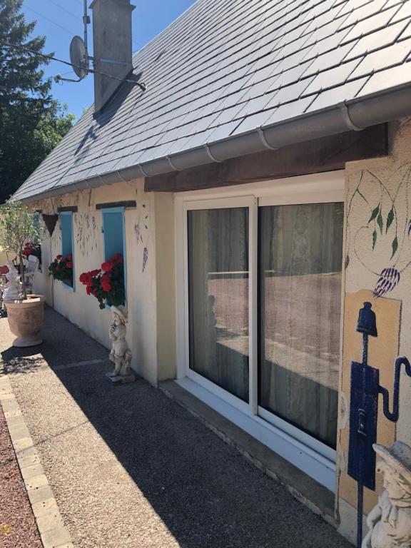 a house with a large window on the side of it at Maison du bonheur in Saint-Mards-de-Fresne