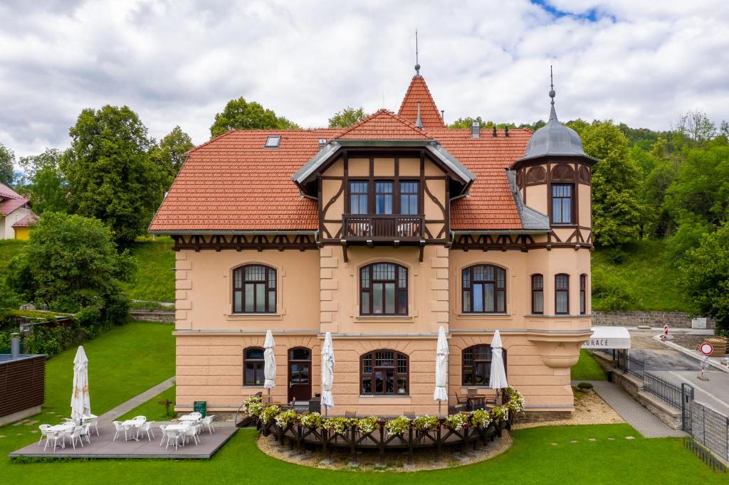 una casa grande con una torreta en el césped en Vila ELIS en Jeseník