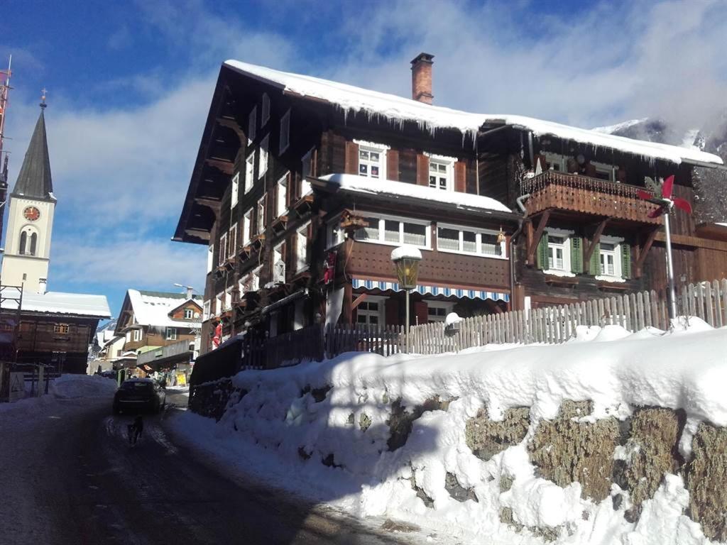 a building covered in snow in front of a building at Landhaus-Willi in Gaschurn