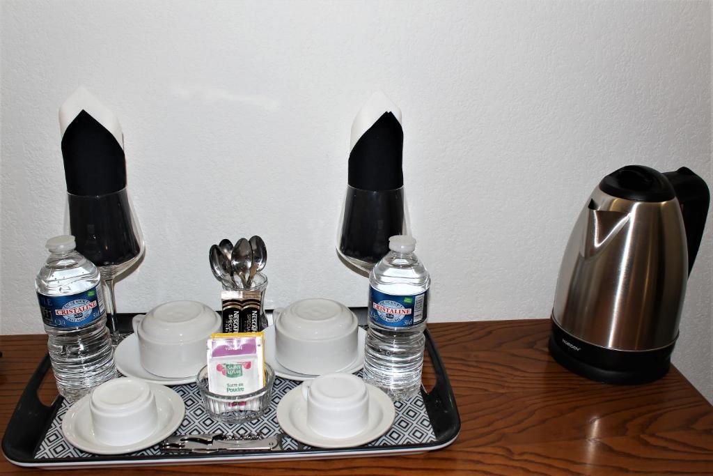 a tray with cups and bottles of water on a table at Village Club Thalassa in Mèze