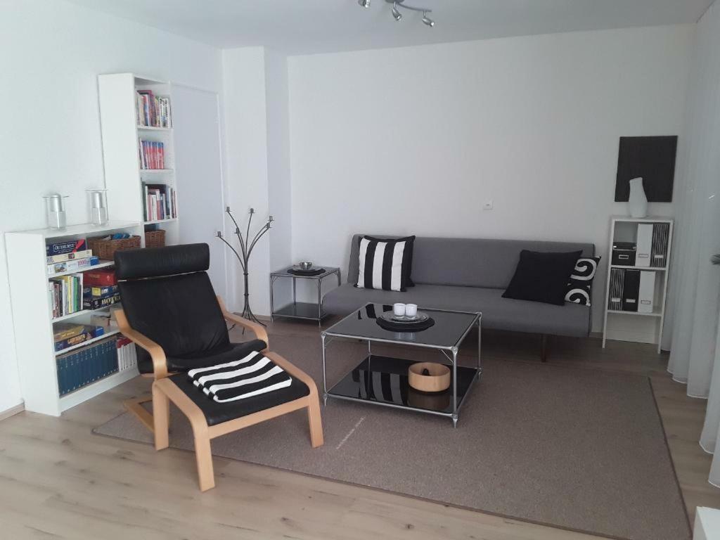 a living room with a couch and a chair at Freundliche Ferienwohnung mit großer Terasse in Aichstetten