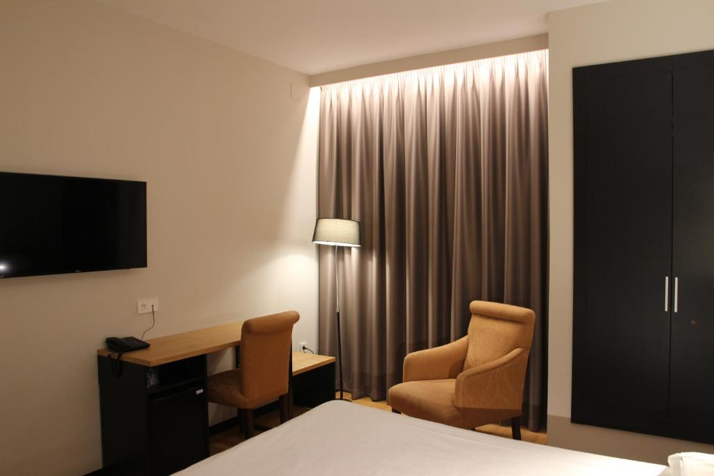 TV a/nebo společenská místnost v ubytování Hotel Alcántara