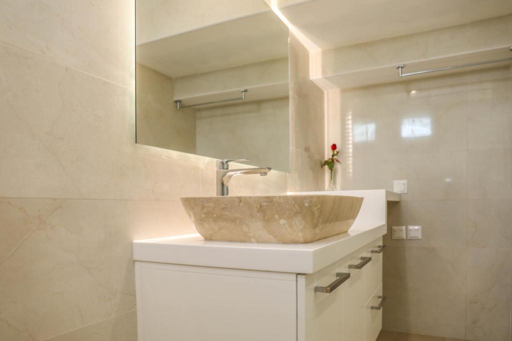 a bathroom with a sink and a mirror at Georgia Villas in Skiathos