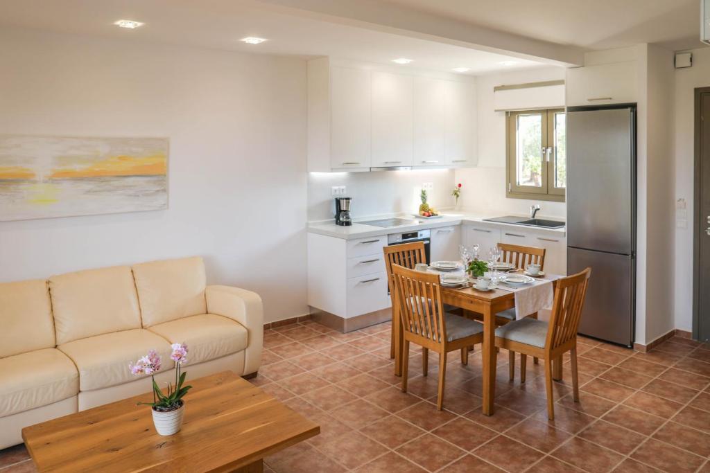 a kitchen and living room with a table and a couch at Georgia Villas in Skiathos