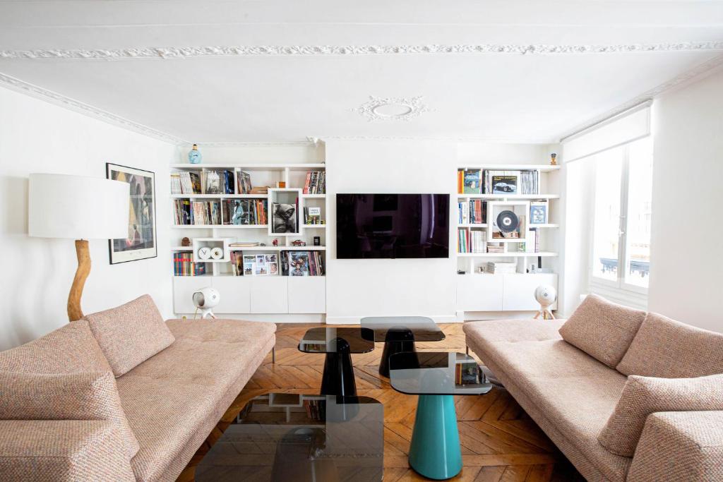 a living room with a couch and a table at Veeve - Chic By Bonne-Nouvelle in Paris