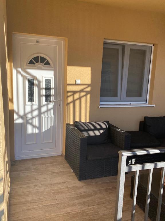 a living room with a couch and a door at Apartments Boss in Budva