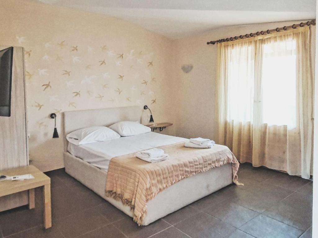 Posteľ alebo postele v izbe v ubytovaní Ammon Garden Hotel