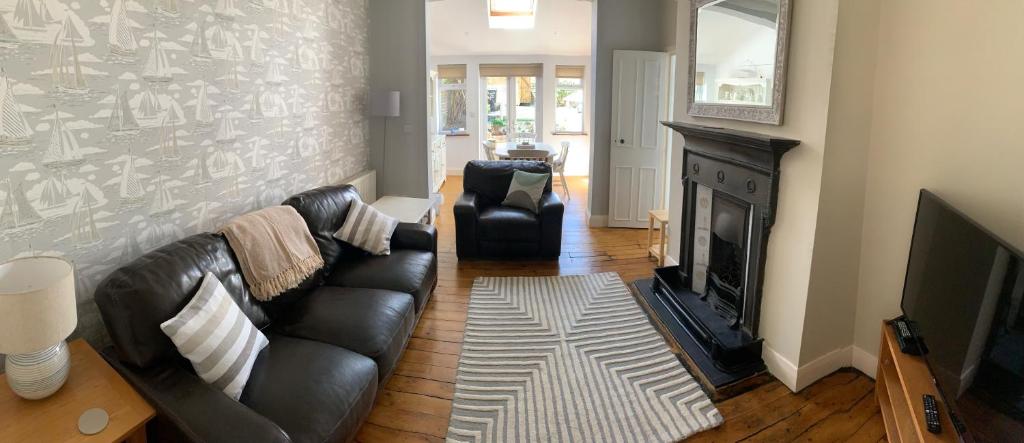 a living room with a couch and a fireplace at Enliven in Broadstairs