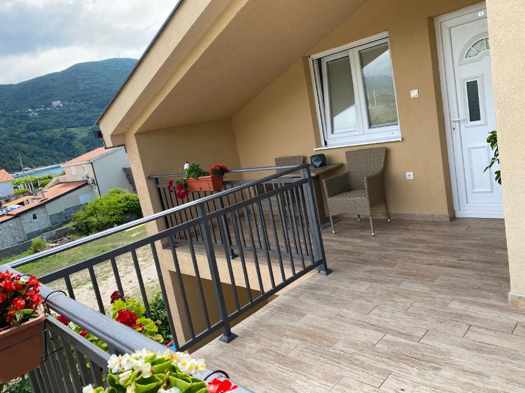 a balcony of a house with a table and chairs at Apartments Boss in Budva