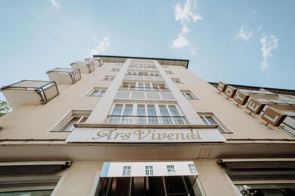 a tall building with the words its interests on it at Hotel Ars Vivendi München in Munich