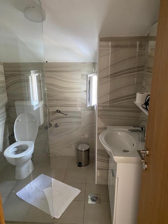 a bathroom with a toilet and a sink at Apartments Boss in Budva