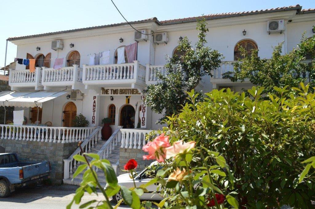 a large white house with a balcony at Two Brothers Parga in Parga